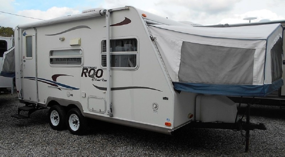 Exterior view of a 2004 FOREST RIVER ROCKWOOD ROO 19 with the bedroom portion extended.