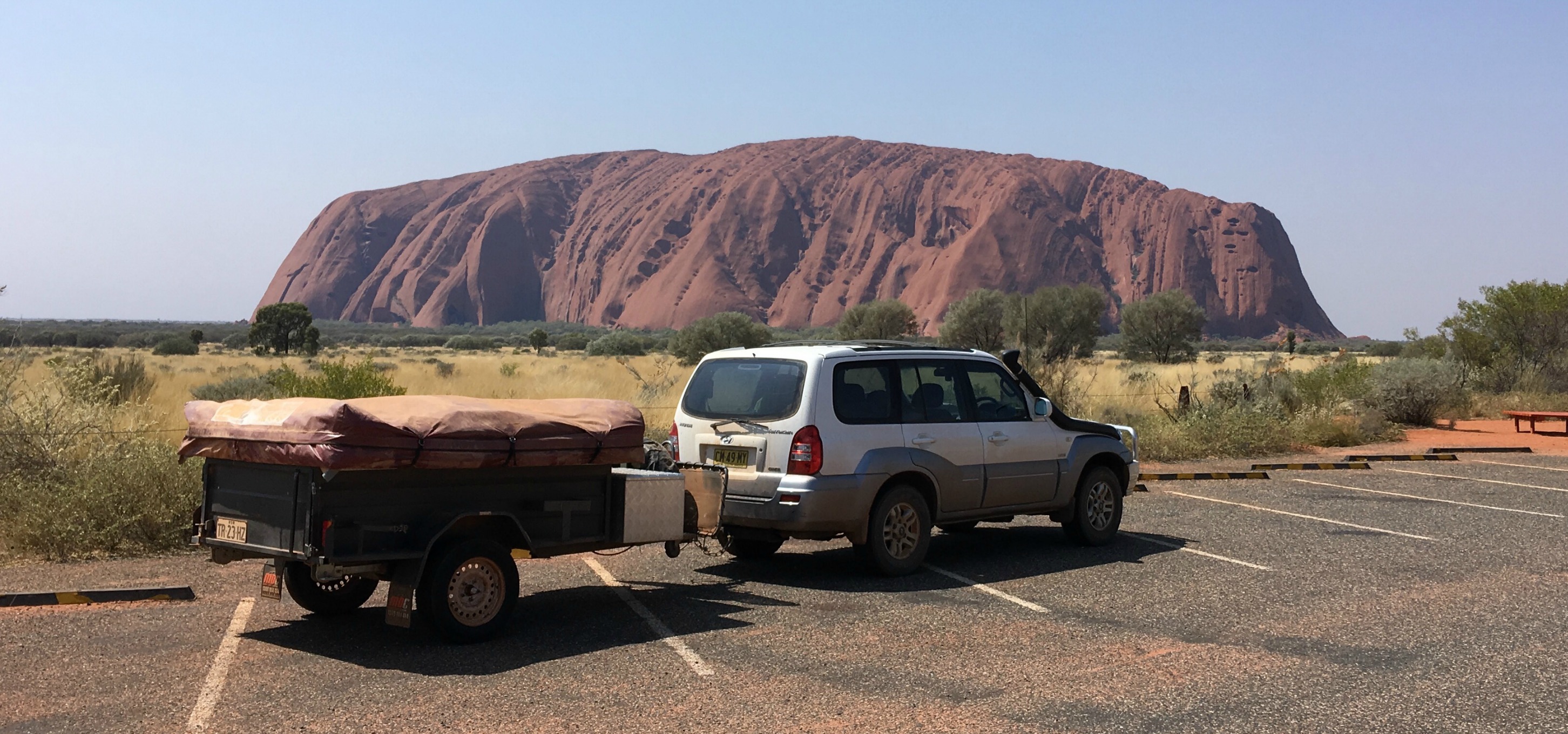 How to earn money while rving - our road trip around Australia - car and camper trailer at Uluru, Northern Territory, Australia
