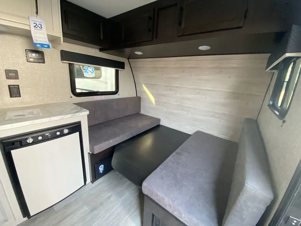 Interior of a Jayco Jay Flight SLX 154BH travel trailer showing the dining area that converts into a bed.