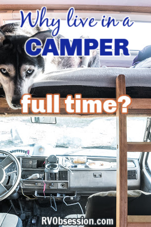 Interior of a Class C camper showing a dog in the bed above the cab; with text overlay: Why live in a camper full time?