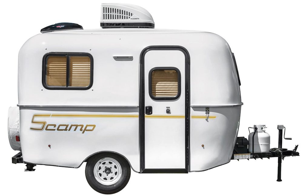 Small 13' Scamp travel trailer exterior side view.
