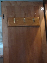 Storage ideas for RV Closets - When you don't have enough space for all your clothes but you still want to look nice while traveling, it's important to organize what space you do have! Add hooks to the inside of the closet door, for all those often used items.