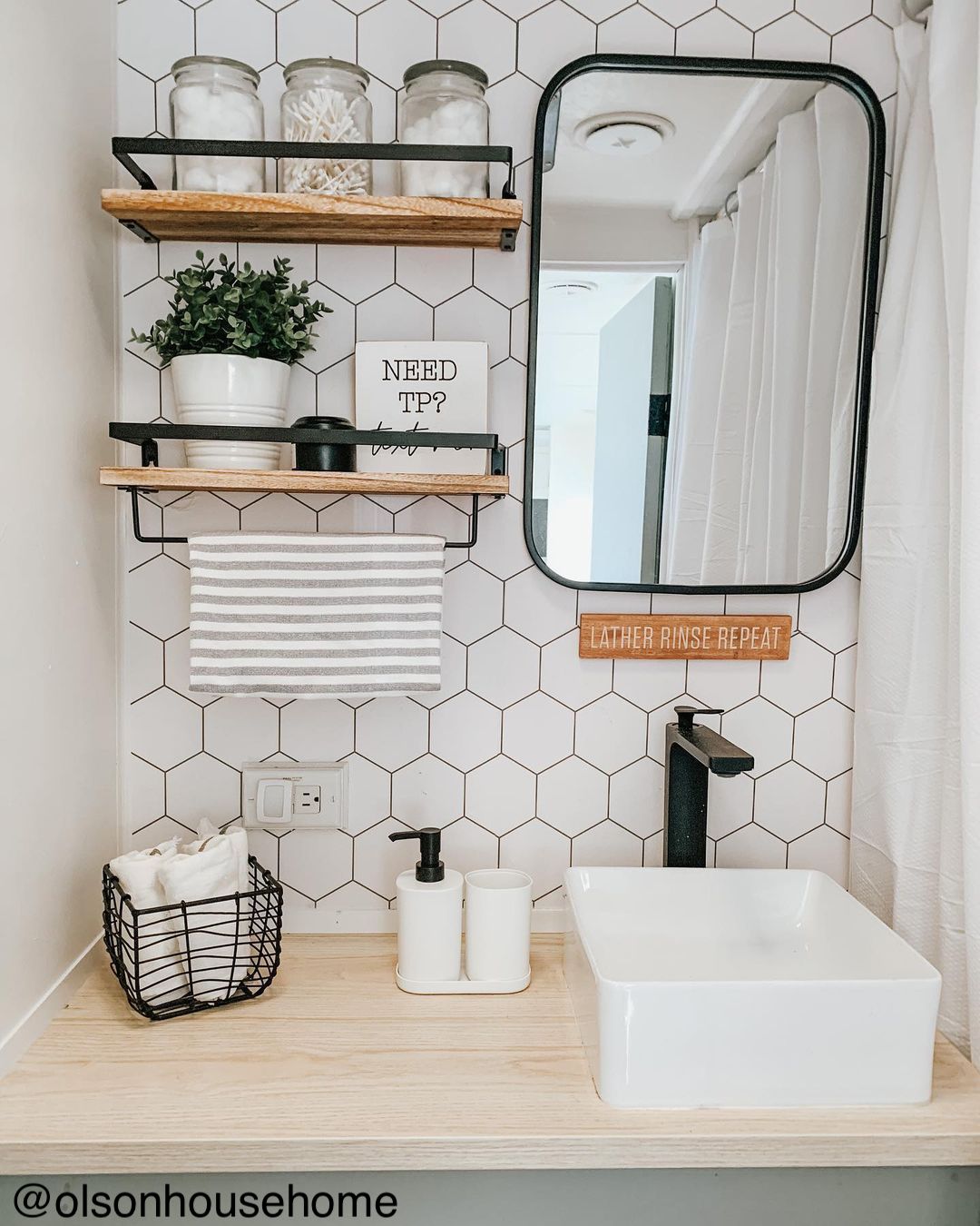 Chic renovation of a travel trailer bathroom with black and white decor.