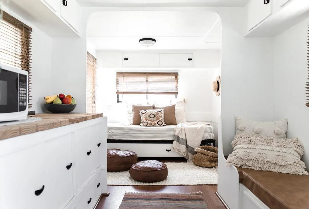 Interior of renovated caravan with mostly white and a few brown accents